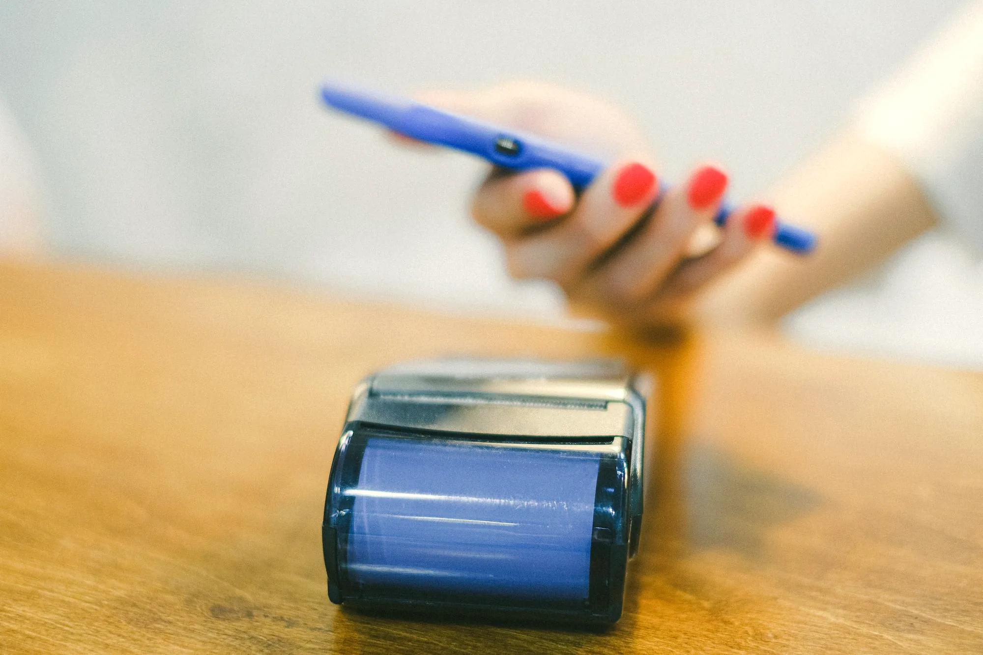 Customer paying with a phone at a payment terminal