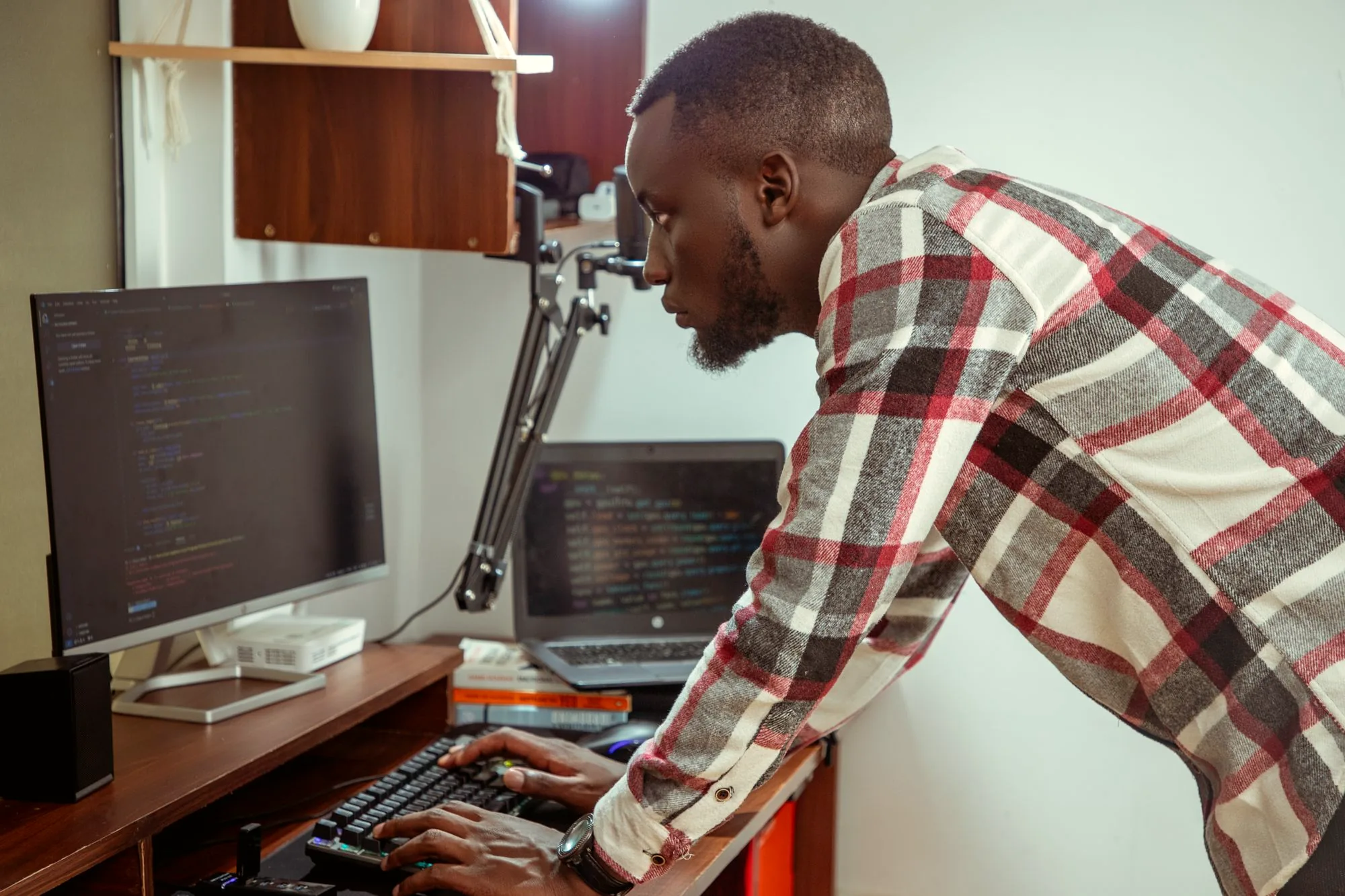 IT specialist working at dual monitors in an office