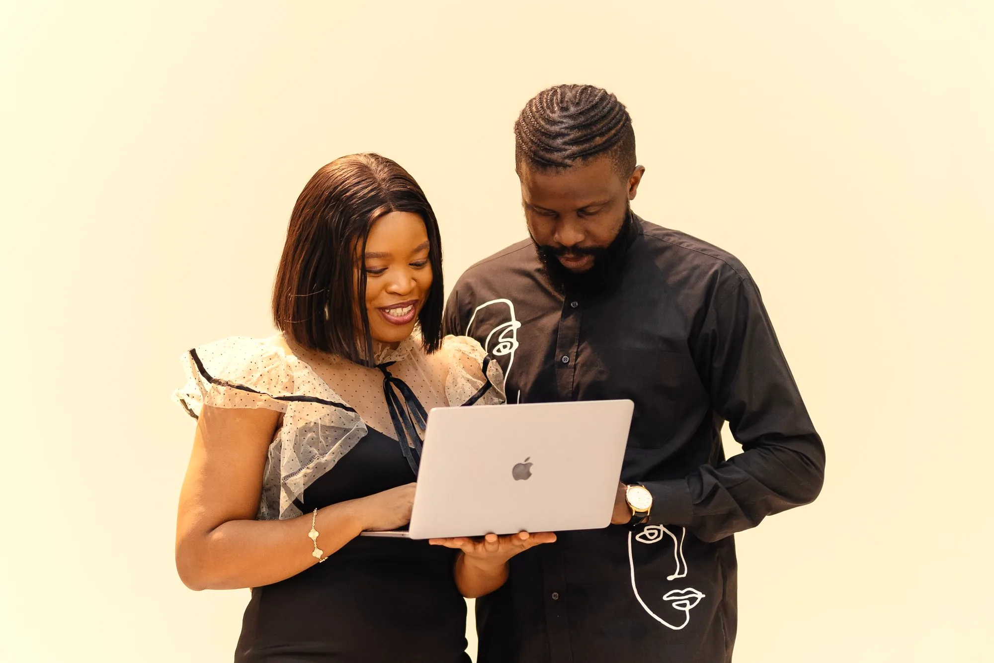 Two colleagues collaborating over a laptop in an office